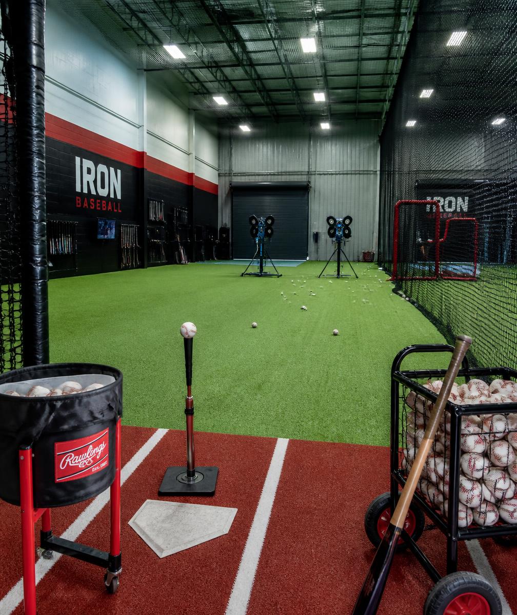 Indoor baseball training facility with pitching machines and batting cages